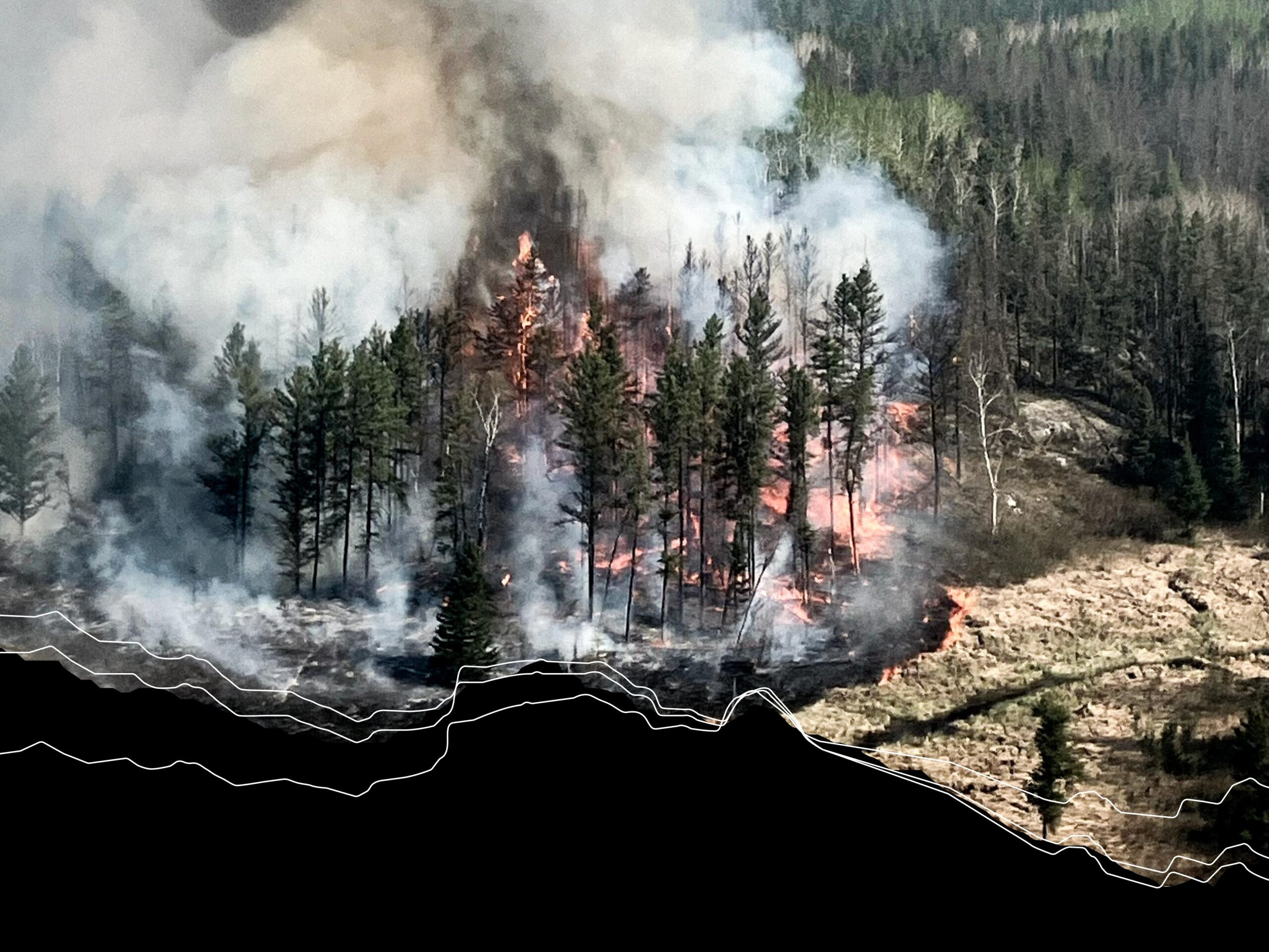 Credit: Lac du Bonnet (1)_Credit to Manitoba Government. 14-May-2025 Wildfire burning through a forest as thick smoke rises above the tree line
