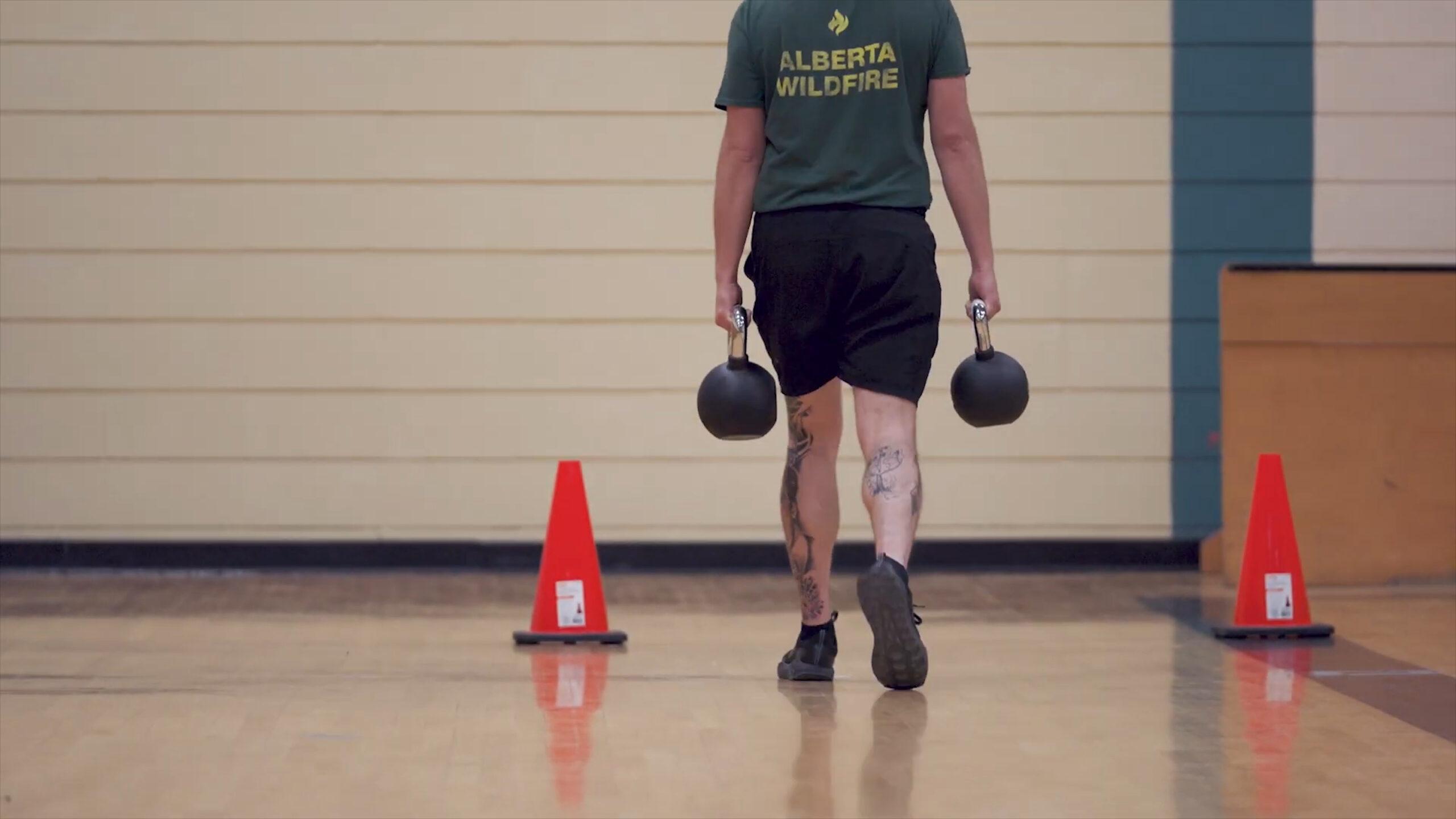 KettlebellCarryWebStill A WFPAT1 test participant carrying one kettlebell in each hand.